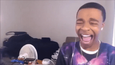 Young Man Wearing Headphones Laughing GIF