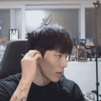 Young Man Wearing Headphones Sitting In Chair GIF