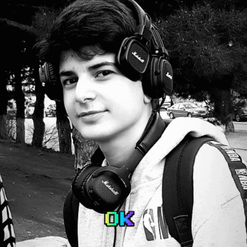 Young Man Wearing Marshall Headphones And Backpack GIF