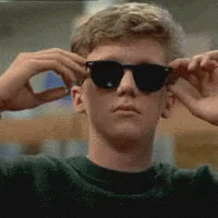 Young Man Wearing Sunglasses And Green Sweater GIF