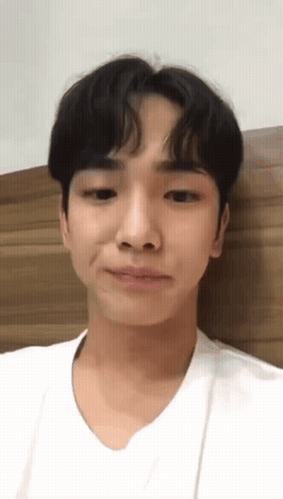 Young Man White Shirt Making Funny Face Against Wall GIF