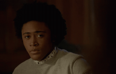Young Man With Afro In Sweater And Polka Dot Shirt GIF
