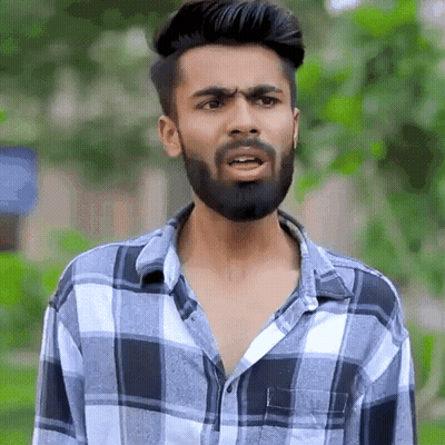 Young Man With Beard In Plaid Shirt GIF