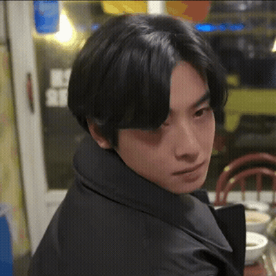 Young Man With Black Hair Sitting At Table With Bowl Of Soup GIF