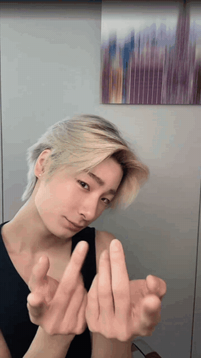 Young Man With Blonde Hair Making Heart GIF