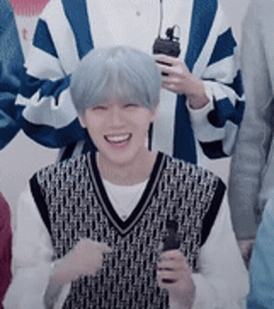 Young Man With Blue Hair Holding Microphone Smiling GIF