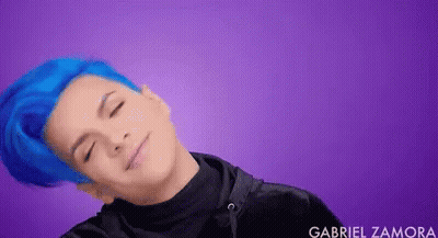 Young Man With Blue Hair Laying Down Eyes Closed Smiling GIF
