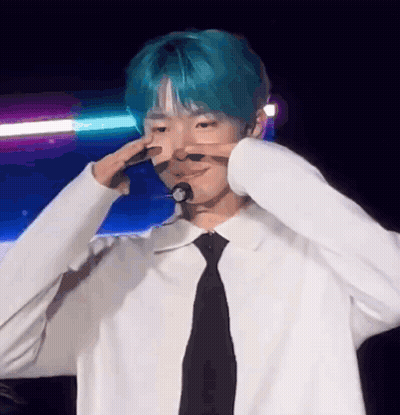 Young Man With Blue Hair Making Peace Sign GIF