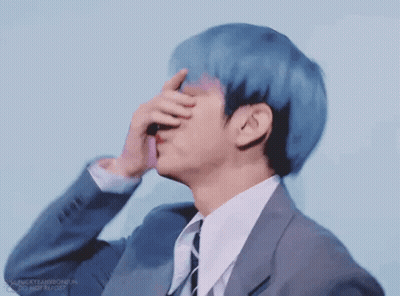 Young Man With Blue Hair Whispering Into Ear