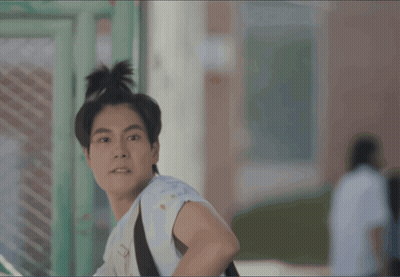Young Man With Bun And Backpack GIF