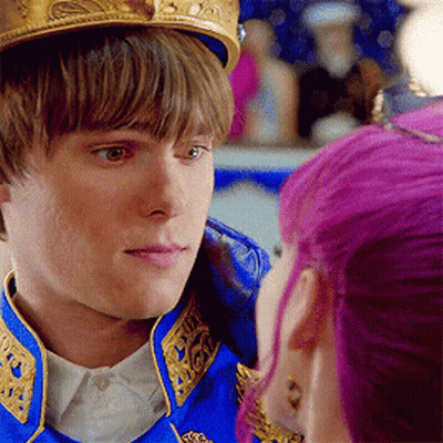 Young Man With Crown Looking At Purple Haired Woman GIF