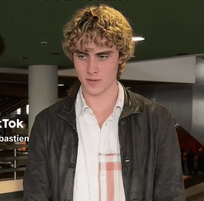 Young Man With Curly Blonde Hair And Leather Jacket GIF