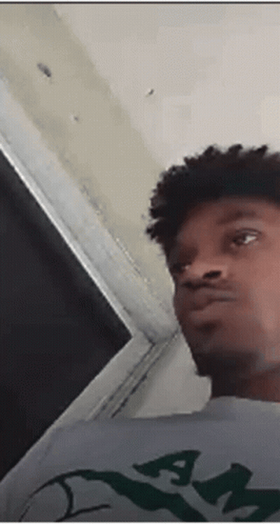 Young Man With Curly Hair And Gray Shirt With Letter A GIF
