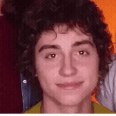 Young Man With Curly Hair Close Up GIF