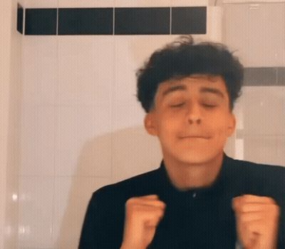Young Man With Curly Hair Funny Face Tiled Wall GIF