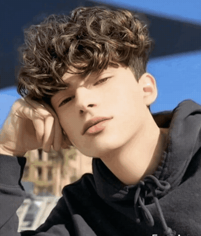 Young Man With Curly Hair In Black Sweatshirt GIF