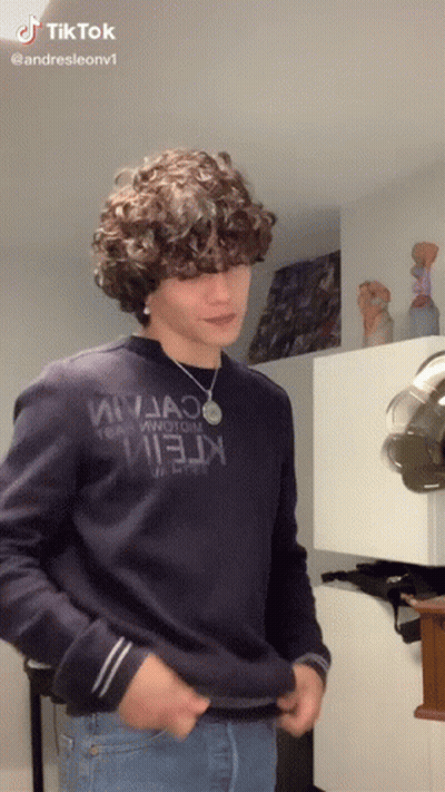 Young Man With Curly Hair In Blue Sweater Saying Ninja GIF