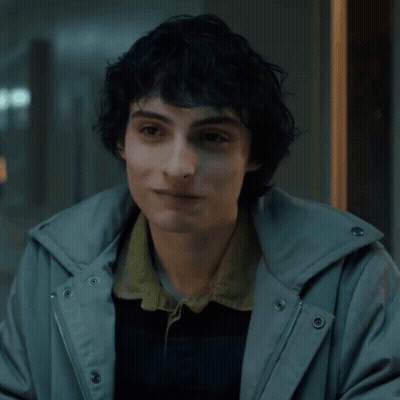 Young Man With Curly Hair In Grey Hoodie GIF