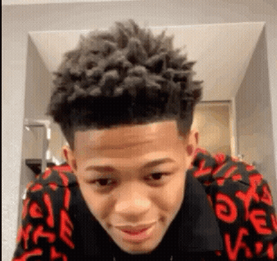 Young Man With Curly Hair In Red And Black Sweater GIF