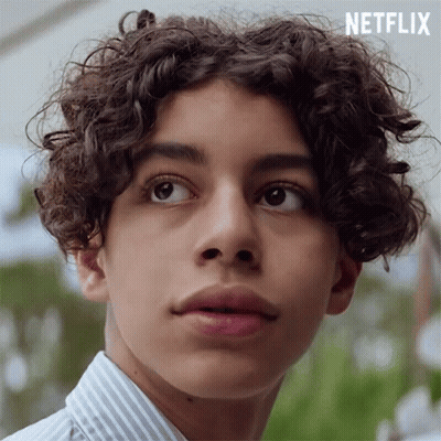 Young Man With Curly Hair In Striped Shirt GIF
