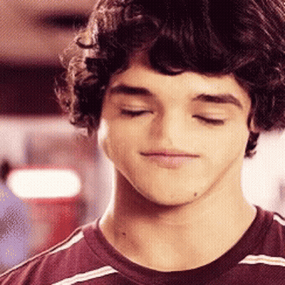 Young Man With Curly Hair In Striped Shirt GIF