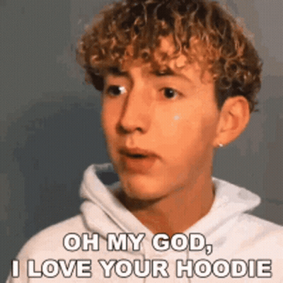 Young Man With Curly Hair In White Hoodie GIF