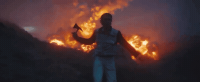 Young Man With Curly Hair Looking At Camera GIF