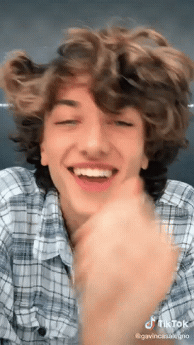 Young Man With Curly Hair Making Funny Face GIF