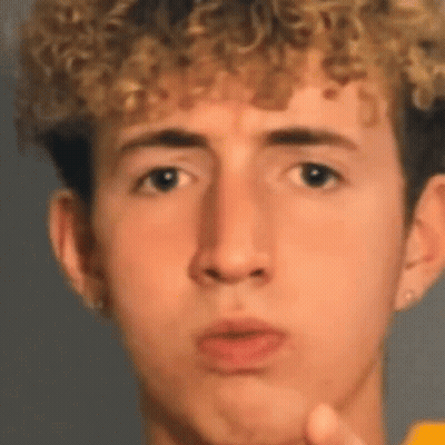 Young Man With Curly Hair Making Funny Face GIF