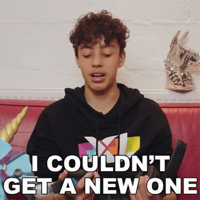 Young Man With Curly Hair Sitting On Couch GIF