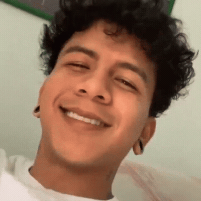 Young Man With Curly Hair Smiling Eyes Closed Mouth Open GIF