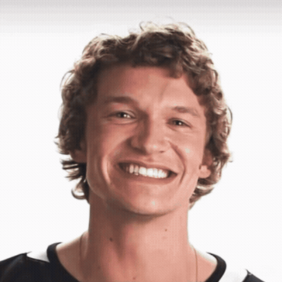 Young Man With Curly Hair Smiling In Black Shirt GIF