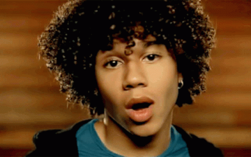 Young Man With Curly Hair Surprised Mouth Open GIF