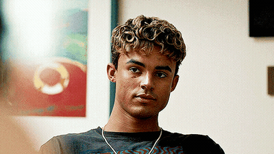 Young Man With Curly Hair Wearing Headphones And Black Shirt GIF