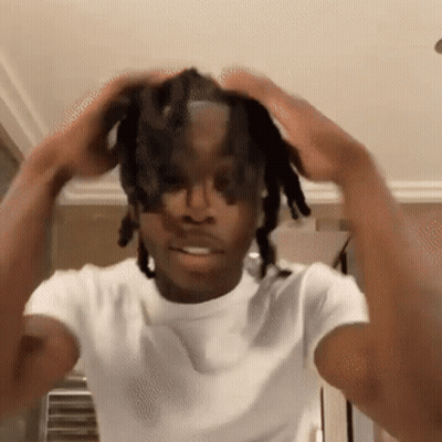 Young Man With Dreadlocks Holding Head In Hands GIF