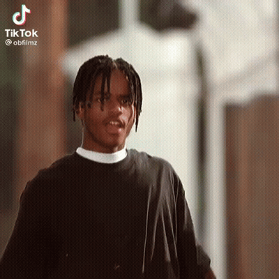 Young Man With Dreadlocks Looking At Camera GIF