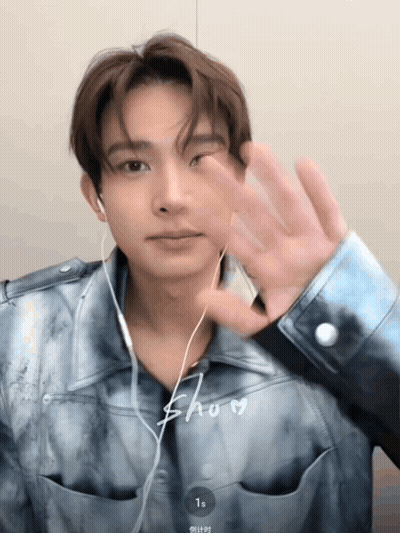 Young Man With Ear Buds And Blue Shirt Saying Show GIF