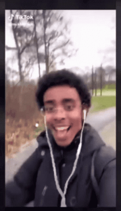 Young Man With Ear Buds Smiling GIF