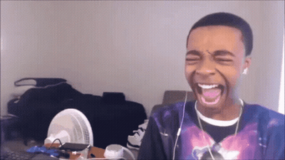 Young Man With Earbuds Laughing GIF