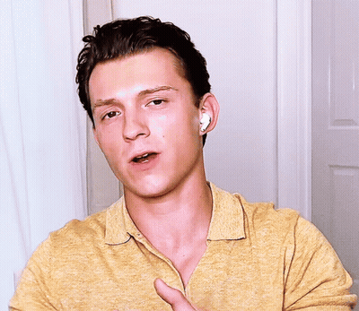 Young Man With Earbuds Making A Face GIF