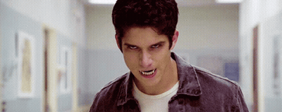Young Man With Fangs Standing In Hallway Eyes Closed GIF