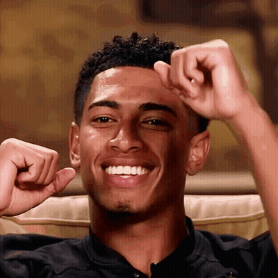 Young Man With Fist In Air Smiling GIF