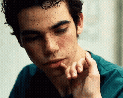 Young Man With Freckles Looking Down GIF