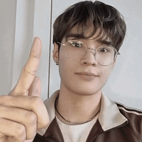 Young Man With Glasses And Brown Jacket Giving Thumbs Up GIF