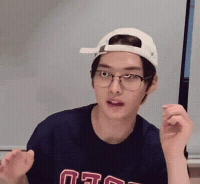 Young Man With Glasses And Hat Making Funny Face GIF