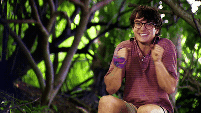 Young Man With Glasses Smiling In Woods GIF