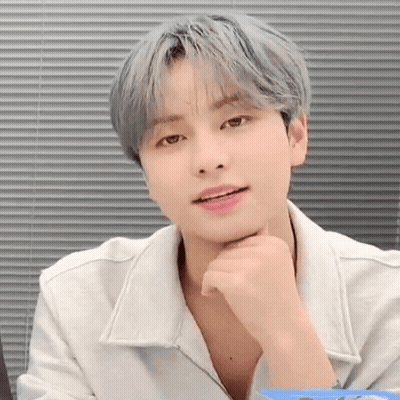 Young Man With Gray Hair Sitting By Window GIF