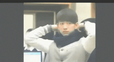Young Man With Hands Behind Head And Scarf GIF