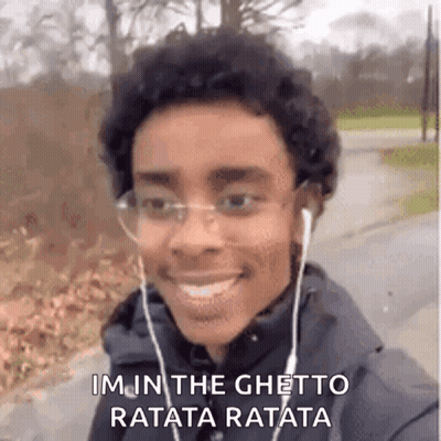 Young Man With Headphones And Glasses Smiling While Walking GIF