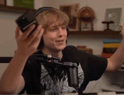 Young Man With Headphones And Microphone At Table GIF